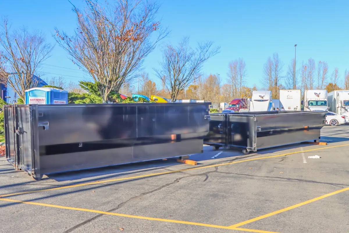 Professional dumpster rental service with roll-off container on residential driveway in Hercules